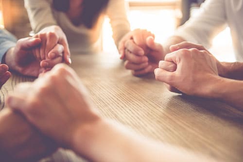 support group holding hands