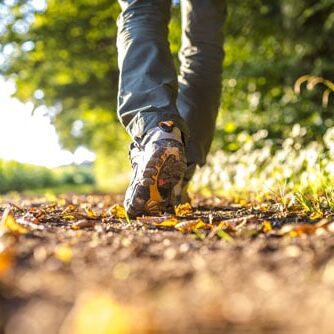 man walking on hiking trail